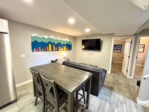 a living room with a table and a couch at Gorgeous 2-King-Bed Lower Unit in Denver in Denver