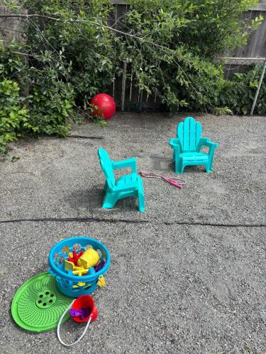 two chairs and a bowl of toys on the ground at Gorgeous 2-King-Bed Lower Unit in Denver in Denver