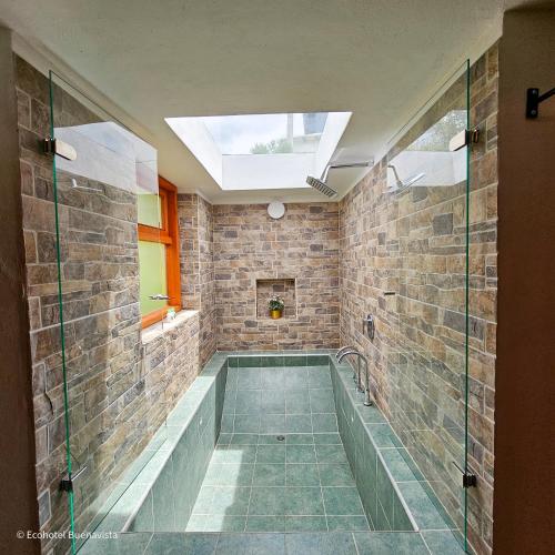 a bathroom with a bath tub and a skylight at Ecohotel Buenavista in Villa de Leyva