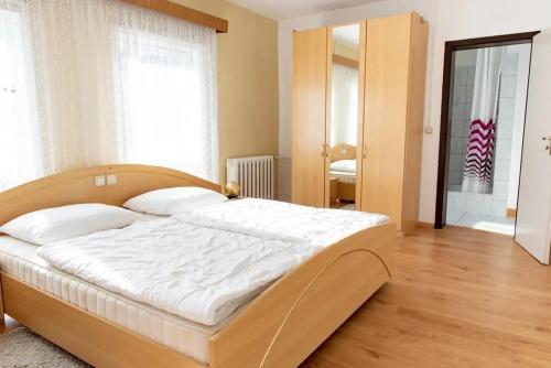a bedroom with a large bed in a room at Hotel Appartementanlage Hermannshöhle in Elbingerode