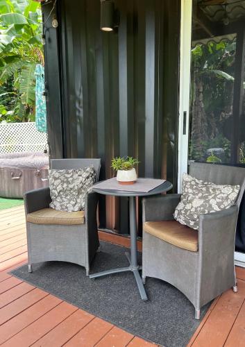 two chairs and a table on a patio at Glamping Mayaguez Just for 2 in Mayaguez
