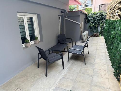 a patio with three chairs and a table and a bench at The Secret Studio - OAKA Stadium & nearby hospitals in Athens