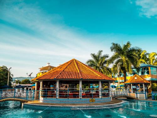 a resort with a swimming pool and a building at HCR Hotel y Centro de Convenciones Chinauta Real in Fusagasuga