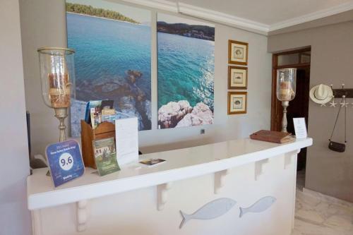 a white counter in a room with a painting on the wall at Faros Suites (Adults Only) in Fiskardho