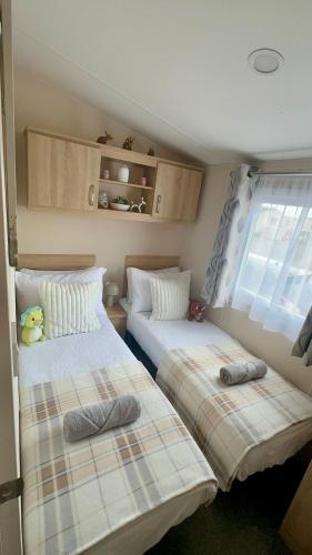 a room with two beds in a small room at Season Stays in Redcar