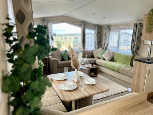 a living room with a table and a couch at Season Stays in Redcar