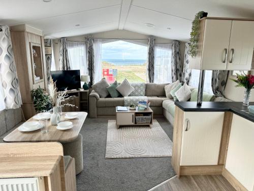 an rv living room with a couch and a table at Season Stays in Redcar