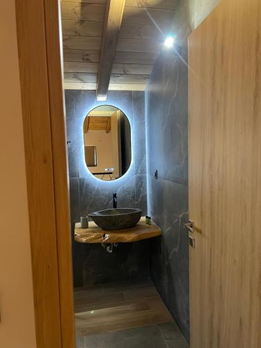 a bathroom with a sink and a mirror at Korifes lithari 01 in Kalabaka