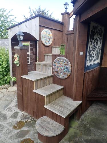 a set of wooden steps with benches and a building at Best Tipi in Morayshire with Whisky Barrel Hot Tub in Coltfield