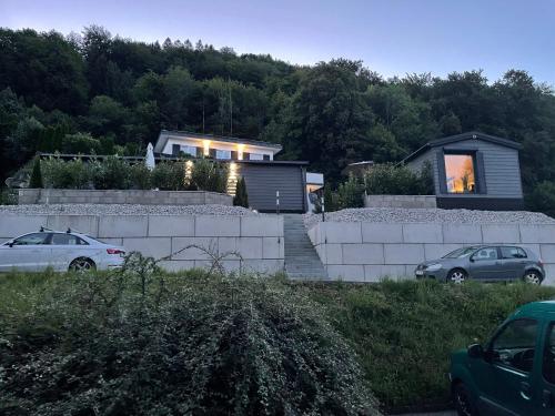 a house with two cars parked in front of it at Premium Chalet A in Ebenzweier