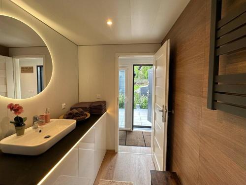 a bathroom with a sink and a mirror at Premium Chalet A in Ebenzweier