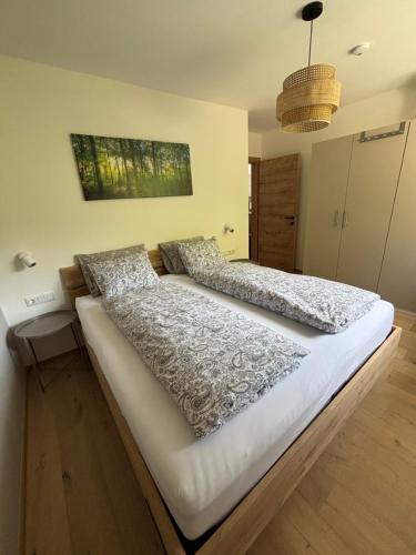 a large bed in a room with two pillows at Panorama Apartment Imst in Imst
