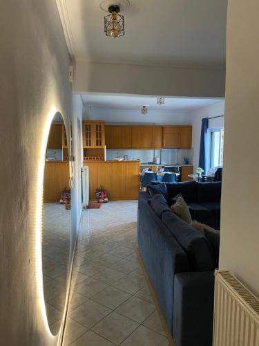 a living room with a couch and a kitchen at Nafpaktio home in Nafpaktos