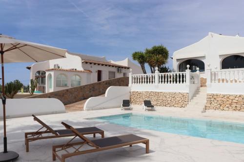 a villa with a swimming pool and a house at Villa Lucya in El Campello