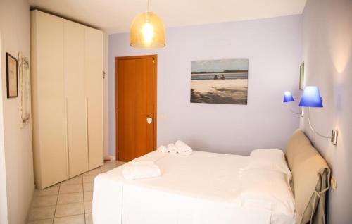 a bedroom with a bed with white sheets at Capalbio Relax - Super terrazza in Capalbio