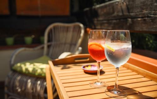 two wine glasses sitting on top of a table at Capalbio Relax - Super terrazza in Capalbio