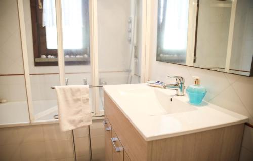 a bathroom with a sink with a blue bottle on it at Capalbio Relax - Super terrazza in Capalbio