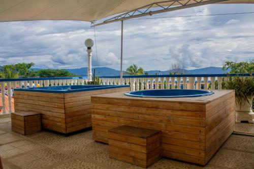 a jacuzzi tub sitting on top of a deck at HCR Hotel y Centro de Convenciones Chinauta Real in Fusagasuga