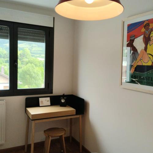 a room with a table and a stool and a window at Basaluze in Alsasua