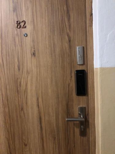 a wooden door with the number on it at Apartament JANA PAWŁA in Włodawa