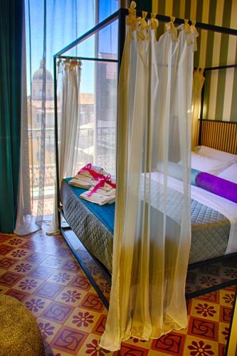 a bedroom with two bunk beds and a window at Roby's Boutique Rooms - Luxury B&B in Catania