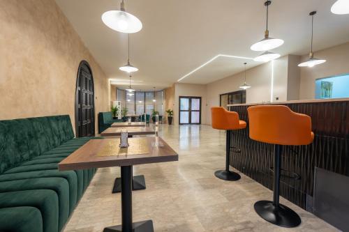 a lobby with green furniture and orange chairs at The GuestHouse Company Limited in Lagos