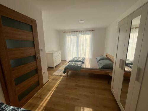 a bedroom with a bed and a window at Ubytování Na Louce in Náchod