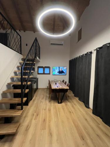 a room with a table and a staircase and a stage at Korifes lithari 01 in Kalabaka