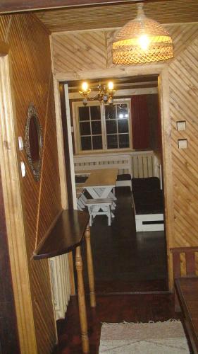 a living room with a table and a couch at Tammekännu Holiday House in Mammaste