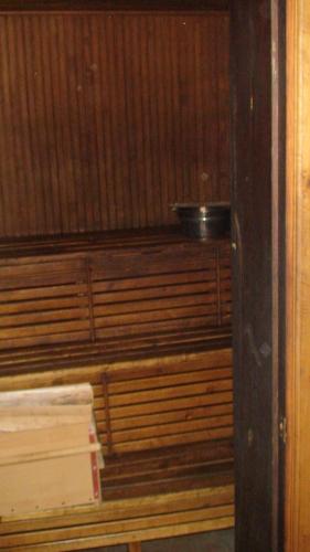a room with wood paneling and a bowl on a shelf at Tammekännu Holiday House in Mammaste
