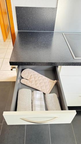 a drawer in a kitchen with three pillows in it at 160 qm Apartment mit Garten und Stellplatz in Riegelsberg