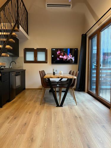 a kitchen and dining room with a table and chairs at Korifes lithari 01 in Kalabaka