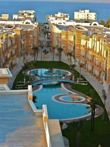 an aerial view of a resort with a swimming pool at New 2-room secure residence, beach, pool in Port El Kantaoui