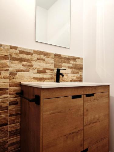 a bathroom with a wooden vanity with a sink at Casa con piscina y jacuzzi in Pontevedra