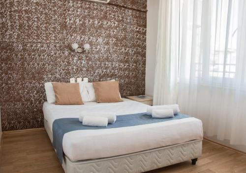 Ένα ή περισσότερα κρεβάτια σε δωμάτιο στο Toros Otel Didim