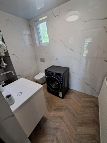 a bathroom with a microwave in the corner of a room at Pokoje na Bocznej in Kudowa-Zdrój