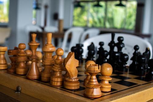 a chess set on a wooden chess board at HCR Hotel y Centro de Convenciones Chinauta Real in Fusagasuga
