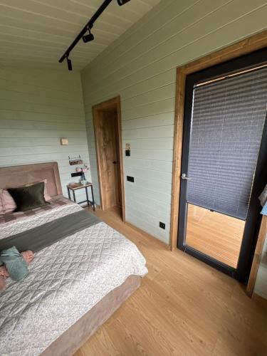 a bedroom with a bed and a large window at Kosuli in Oriv