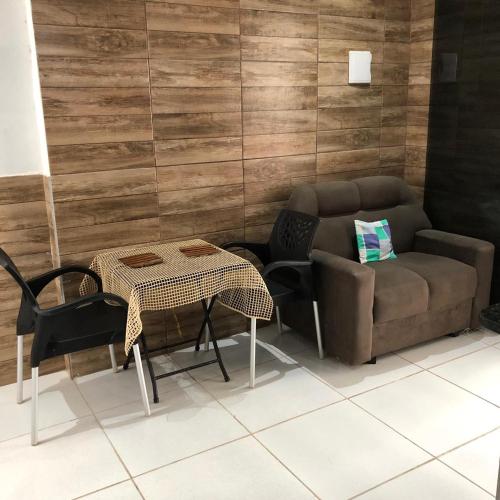 a living room with a couch and a table at Especial Beira Mar in Maragogi
