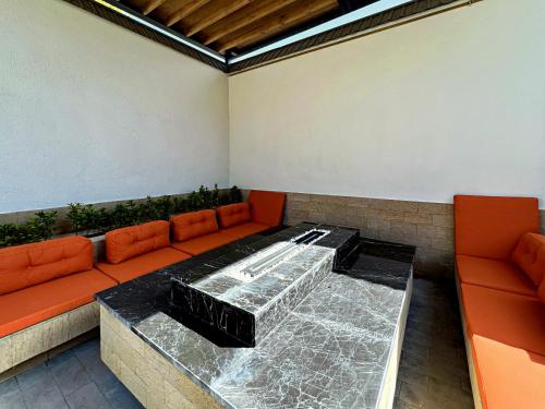a living room with a couch and a table at Qabala Twins Villa two in Gabala