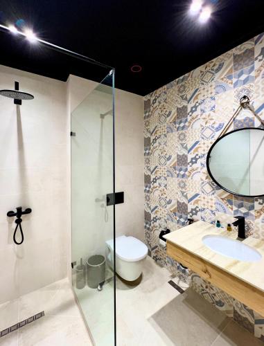 a bathroom with a toilet and a sink and a shower at Qabala Twins Villa two in Gabala