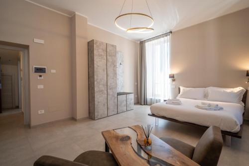 a bedroom with a large bed and a table at Domus Nursia in Norcia