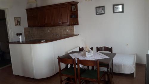 una cucina con un tavolo e un letto in una stanza di Villa 1930 first floor a Vóroi