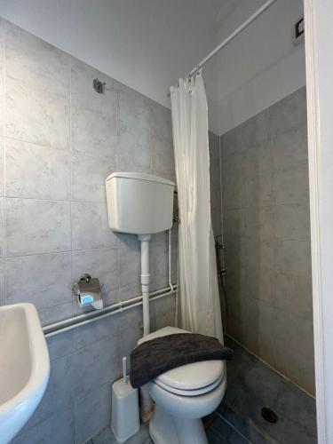 a bathroom with a white toilet and a sink at ERRIKA in Ermoupoli