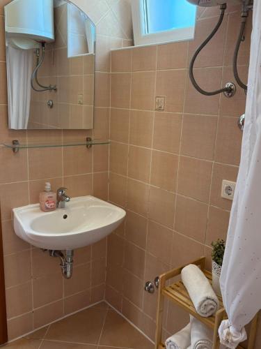 a bathroom with a sink and a shower at APP Mirela 3 in Novi Vinodolski