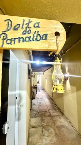 a sign that readseat a parader hanging from a hallway at Casa Piauí Hostel in Teresina