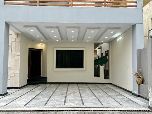 a hallway of a building with a painting on the wall at Islamabad Family Residence in Islamabad