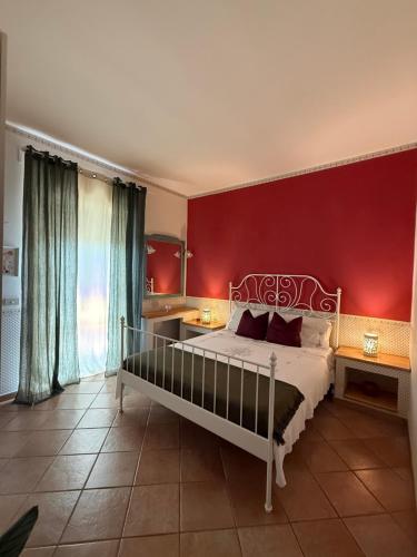 a bedroom with a bed and a red wall at D Amuri Sea Home in Siracusa