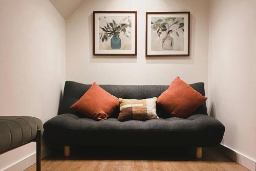 a couch with pillows on it in a room at At The Bay in St. Andrews