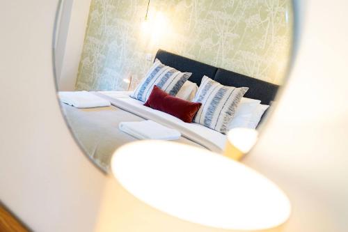 a mirror reflection of a bed in a room at At The Bay in St. Andrews